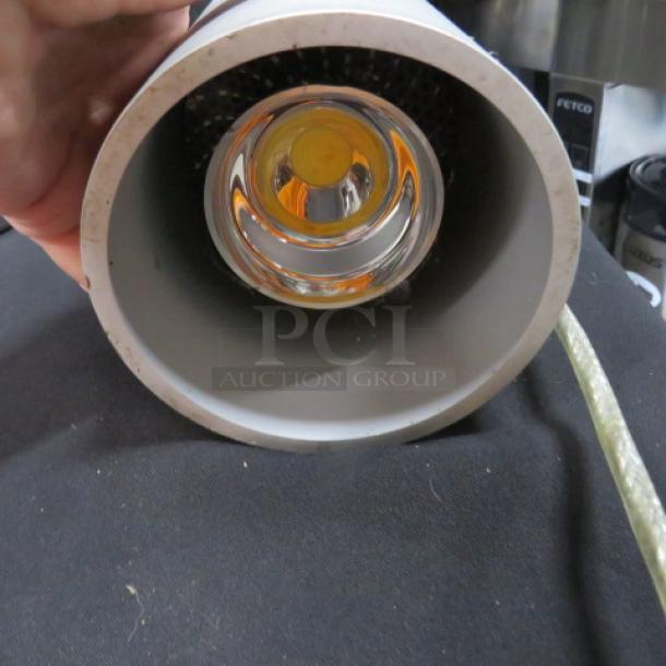 4.5X12 pendant light with a cylindrical design, shown from the bulb end. Model 4XBID. In good condition.