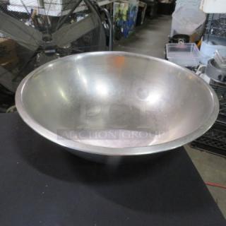 16-inch stainless steel mixing bowl, slightly worn. Ideal for large recipes, durable kitchenware. No visible markings.