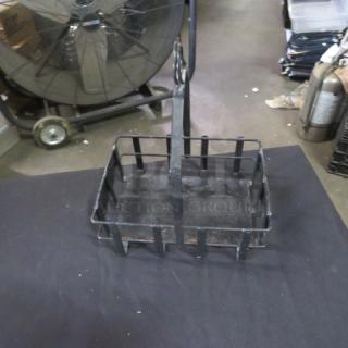 Black metal tabletop condiment holder with five sections, sturdy construction, slightly worn finish, ideal for restaurant use.