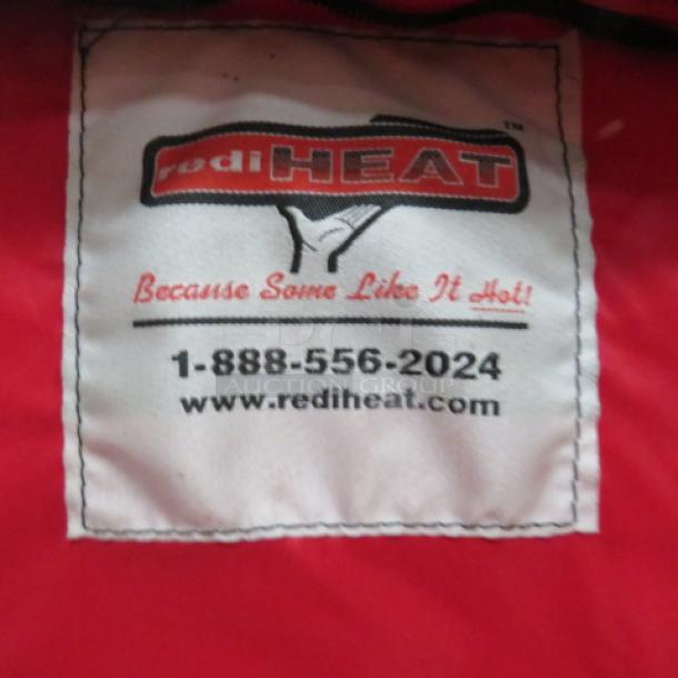 Redi Heat heated pizza bag with label showing contact info and slogan "Because Some Like It Hot." Brand logo visible.