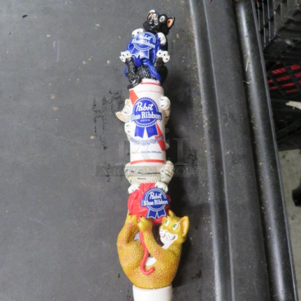 Pabst Blue Ribbon beer tap handle with whimsical cat design, vibrant colors, good condition.