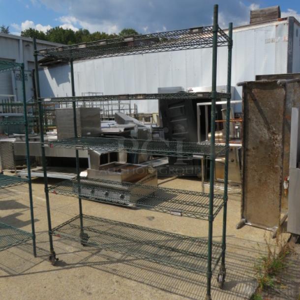 Green Metro shelf with 5 wire shelves on casters. Dimensions: 60x18x80.5 inches. Used condition, outdoor setting.