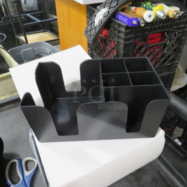 Black bar organizer, new condition, multiple compartments for storage, durable plastic material, ideal for bar accessories.