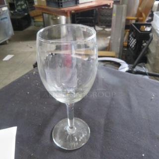 Clear stem wine glass; used condition; slight smudges visible; suitable for wine enthusiasts or collectors.