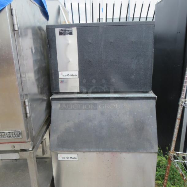 Ice-O-Matic ice maker model ICEO400HAZ, 115V, size 30x32x58 inches, in used condition. Visible brand and model labels.