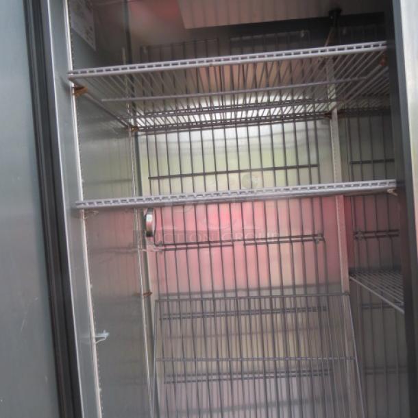True T-49F-HC 2 Door Freezer, 6 racks, on casters, model T49F-HC, 115V, 54x30x83 inches. Interior view shows spacious racks.