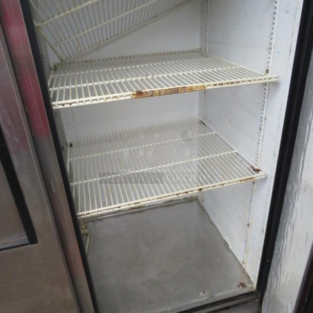 True T-49 two-door refrigerator, 5 racks, on casters, 54x30x83 inches, not working, visible rust on interior shelves.