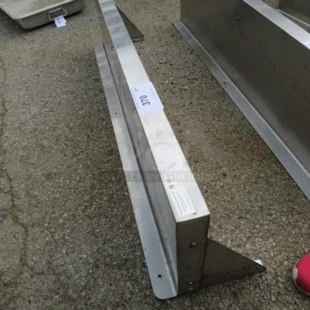 Stainless steel wall mount shelf with two brackets, 48x12 inches, in good condition with visible label detailing specifications.