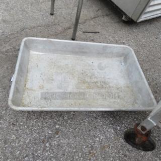 Large metal roasting pan, 26x18 inches, showing signs of wear and discoloration. Ideal for high-capacity cooking.