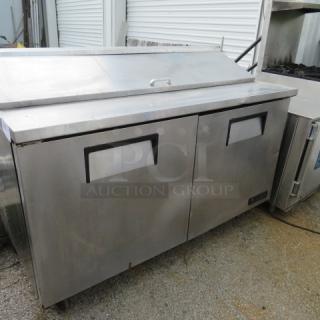 True TSSU-60-16 2 Door Prep Table, 60x30x43", on casters, not working, includes 2 racks, 115V. Stainless steel exterior.
