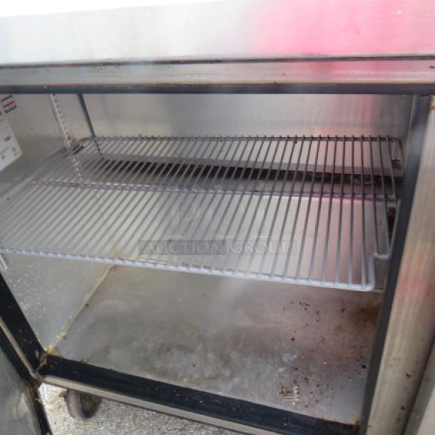 True TSSU-60-16 prep table, 2-door, 2 racks, on casters. 60"x30"x43". 115V, non-working. Some wear shown inside.