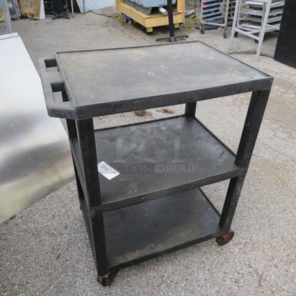 Three-shelf poly cart on casters, black, with handles and visible surface wear.