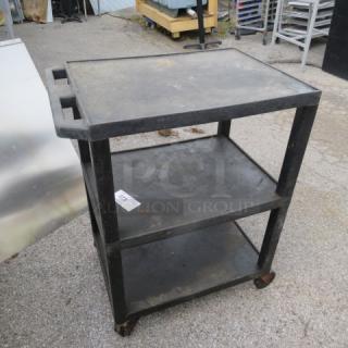 Three-shelf poly cart on casters, black, with handles and visible surface wear.