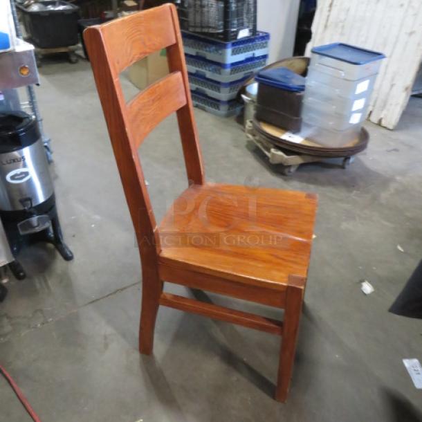 Solid wood chair with a high back, natural finish, sturdy construction. Model 5XBID, excellent condition.