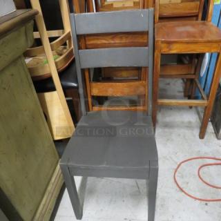 Solid wood high-back chair painted gray, featuring sturdy construction, minor wear visible, perfect for home decor.