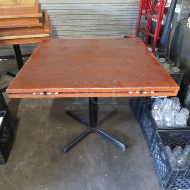 Solid wood table with flip-up sides, 36x36x29 inches, expands to 42-inch round. Features a pedestal base.
