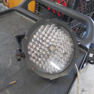 Stage light with bracket, featuring multiple LED bulbs. In working condition with visible power cord. Suitable for events.
