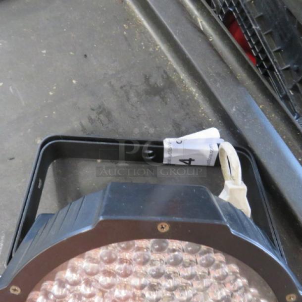 One working stage light with bracket in good condition, featuring a metal frame and a power cable.