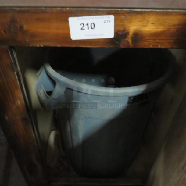 Wooden metal trash receptacle with stainless steel top and visible trash can. Slightly worn finish, auction tag number 210 displayed.