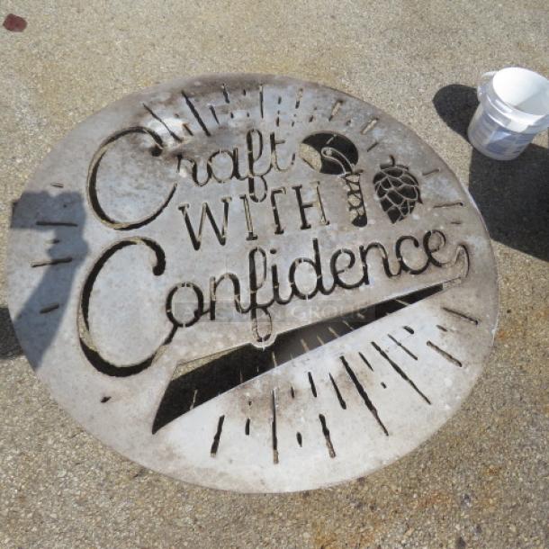 Round aluminum wall sign, 42-inch, with "Craft With Confidence" text and graphic cutouts. Rustic condition.