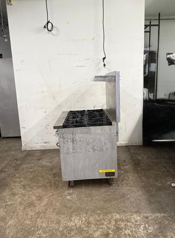 Stainless steel 6 burner gas stovetop and oven in used condition, featuring durable construction and six cast iron burners.