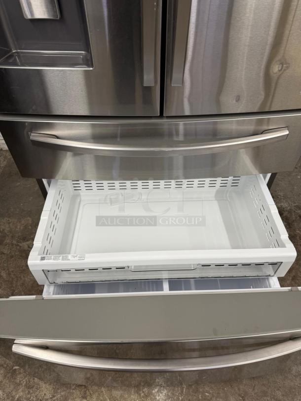 Samsung 4-Door French Door Smart Refrigerator, stainless steel, with open FlexZone Drawer showing interior compartments.