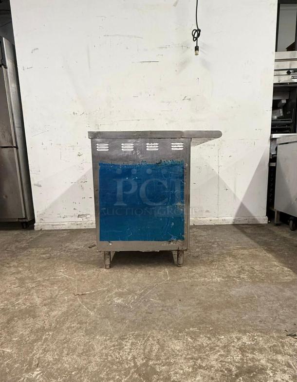 Stainless steel undercounter steam table, featuring a blue protective film, in used condition.