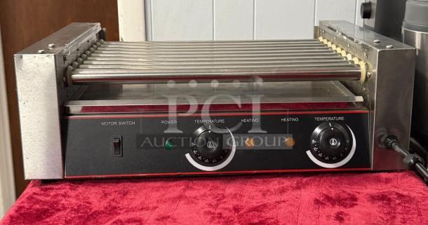 Hot Dog Roller Grill XCJ-9CZ-US, slanted top, manual controls, 120v, used condition, dual temperature knobs, metal exterior.