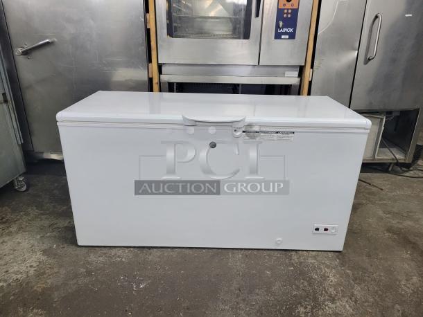 GE 65-inch wide chest freezer, model FCM16SLB, 15.7 cu. ft., Energy Star rated. Tested and working. White exterior.