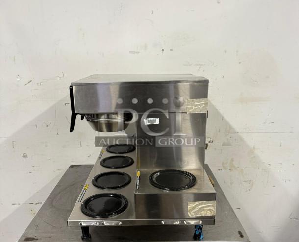 Bunn Axiom 0/6 Twin 12 Cup Coffee Brewer with six lower warmers, stainless steel, good condition, auction label visible.