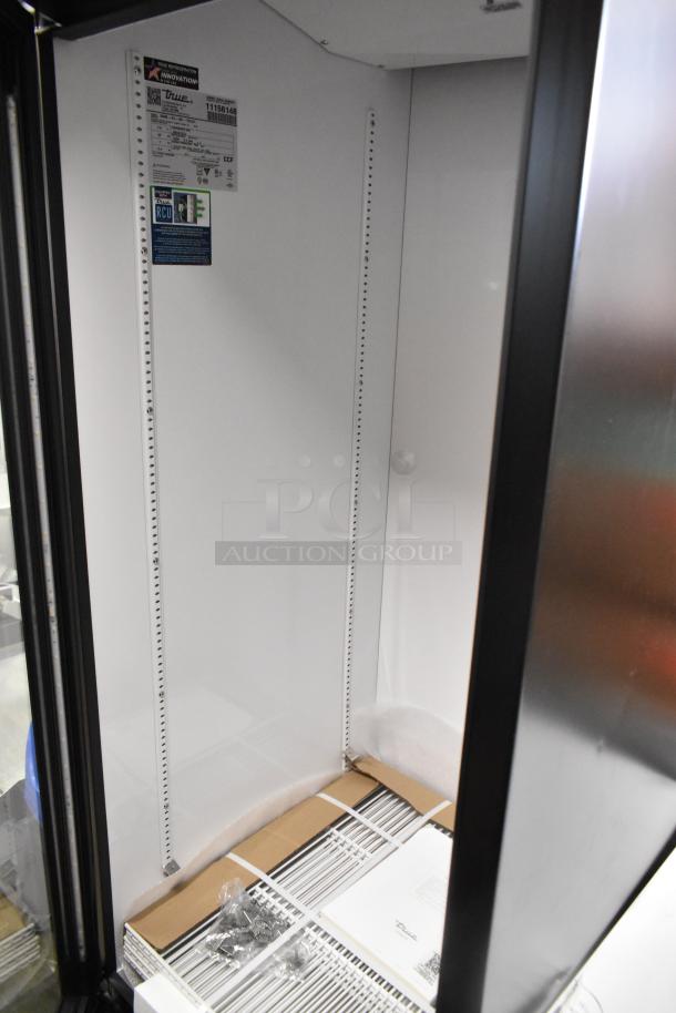 Brand new True GDM-23-HC single door cooler, metal finish, poly coated racks, 115V, 1 Phase, interior tags visible.