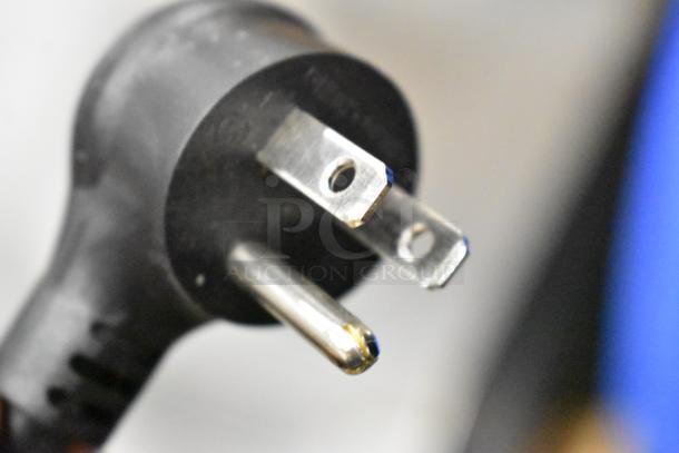 Close-up of a power plug for a True GDM-23-HC cooler, 115 Volts, 1 Phase. Plug shows standard three-prong design.