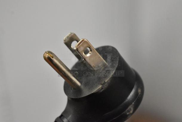 Close-up of a 115V power plug for True GDM-23-HC cooler. Features three prongs and minor wear.