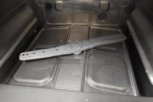 Brand new Noble 495HTUC24 stainless steel undercounter dishwasher interior; high temp, commercial use, minor scratches.