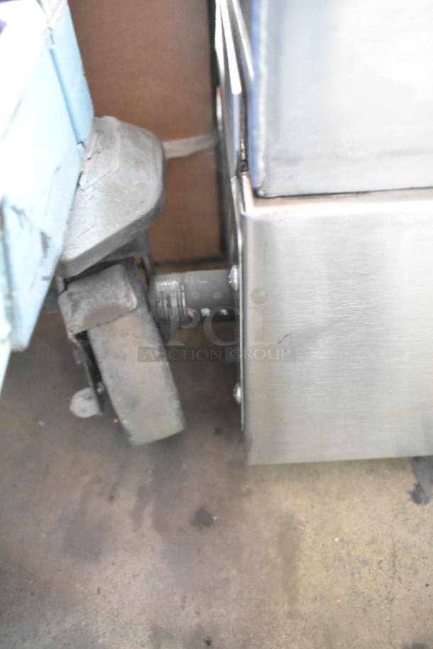 Stainless steel corner of a Therma-Tek TC36-36TGL griddle, with a caster wheel in frame.