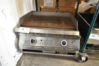 Stainless steel commercial gas griddle, countertop model. Features flat top surface, dual controls. Used condition. Auction lot tag visible.