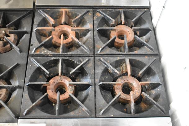 Royal stainless steel 4 burner gas range, countertop model, commercial grade. Visible wear on burners. Suitable for high-demand kitchens.