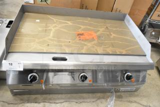 Brand new Garland 2151197 stainless steel commercial countertop flat top griddle, featuring durable construction and control knobs.