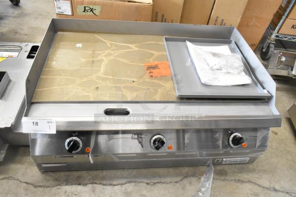 Brand new Garland 2151197 stainless steel commercial countertop flat top griddle. Features temperature dials, labels visible.