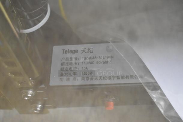 Telege TGZAUA6-A1L1AGN white metal cabinet with label, model details, 110VAC 50/60Hz, 15A, 1650W. Door won't open.