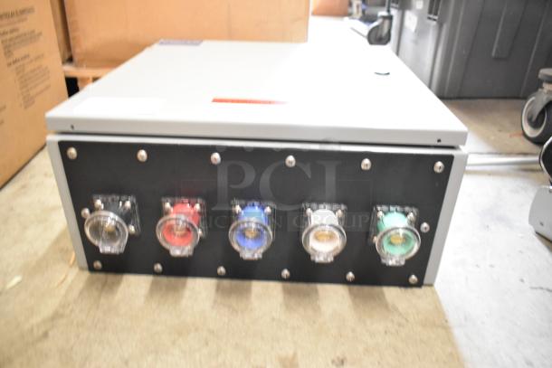 Power Assemblies gray metal box with five multicolored outlets on black panel, used condition, industrial equipment.