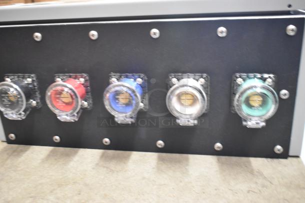 Power Assemblies gray metal box with five colorful input connectors; black, red, blue, white, and green on black panel.