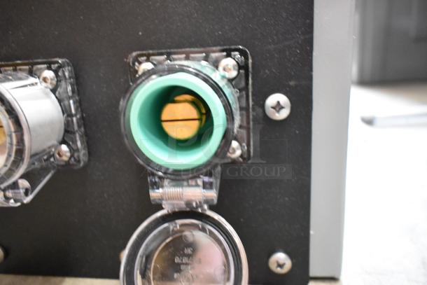 Power Assemblies gray metal box featuring green and black connectors, visible screw fastenings, and clear protective covers.