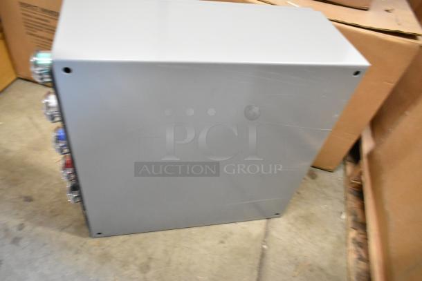 Power Assemblies gray metal box, lightly scratched, featuring side-mounted connectors. Ideal for electrical assembly.