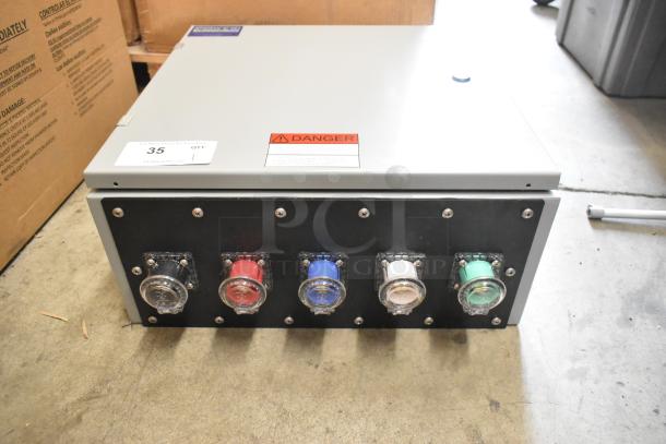 Gray metal Power Assemblies box with multiple colored connectors. Visible warning label indicates electrical hazard.
