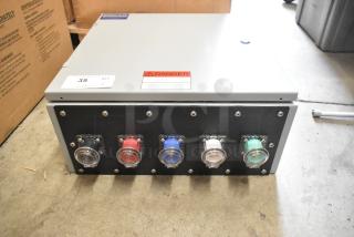 Gray metal Power Assemblies box with multiple colored connectors. Visible warning label indicates electrical hazard.