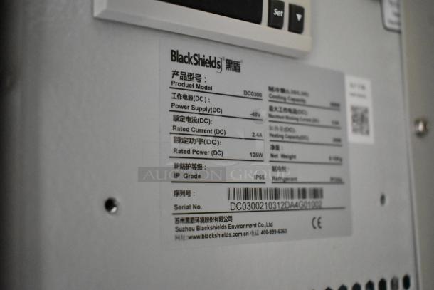 Brand new BlackShields DC0300 white metal cabinet, features label with power specifications, IP55 rating, serial number visible.
