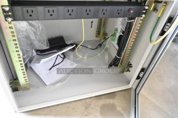 Brand new BlackShields DC0300 white metal cabinet, open door, power outlets, wiring, and documents visible inside.