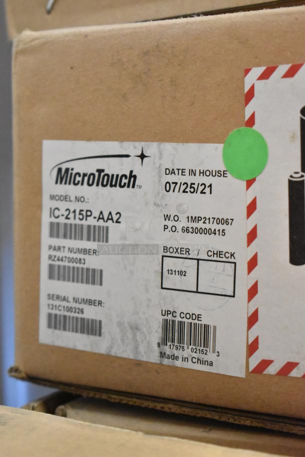 Brand new MicroTouch IC-215P-AA2 monitor in box. Label shows model, serial, part numbers, UPC, and made in China.