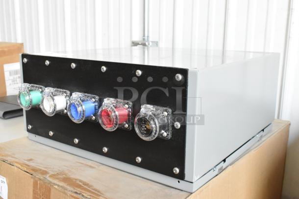 Gray metal Power Assemblies box, new in box, with multiple colored sockets. Durable construction, ideal for power distribution.